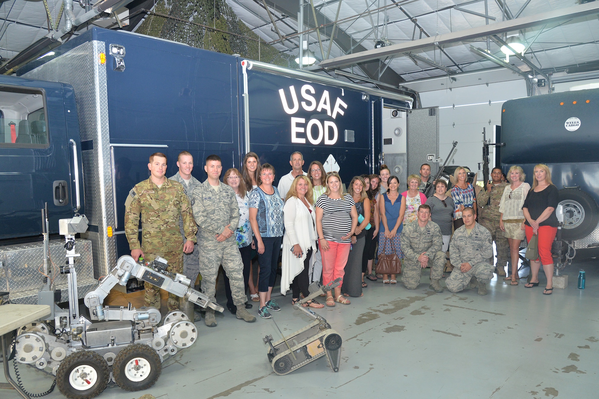 Faculty and staff from Loy Elementary School pose for a photo during a base tour Aug. 29, 2016, at Malmstrom Air Force Base, Mont. The tour began with a visit to the 341st Civil Engineer Squadron Explosive Ordnance Disposal team where attendees had a chance to put on equipment and control robots used during missions. (U.S. Air Force photo/Airman 1st Class Daniel Brosam)