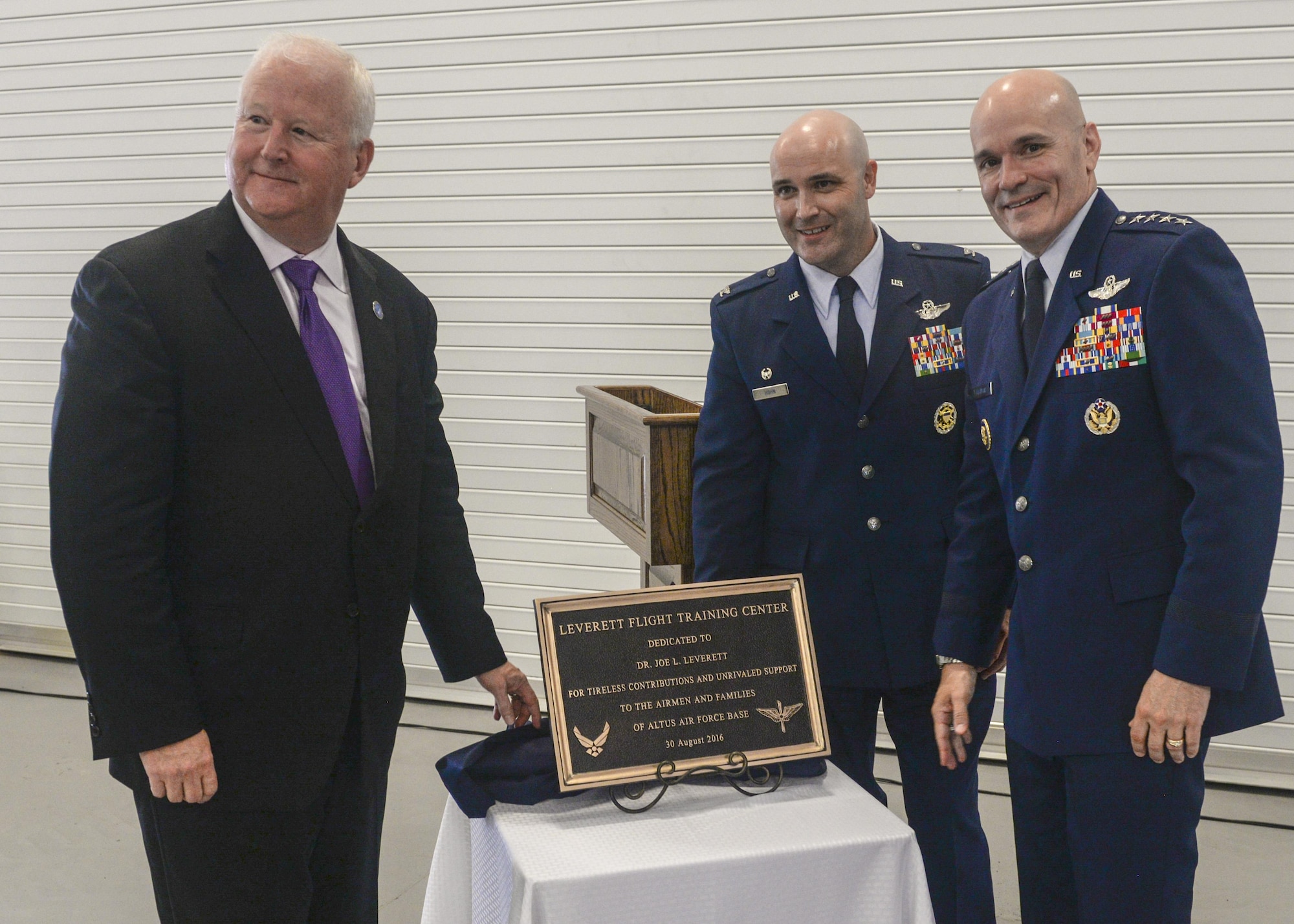 Dr. Joe Leverett, Chairman of the Altus Military Affairs Committee, along with U.S. Air Force Col. Todd Hohn, commander of the 97th Air Mobility Wing, and U.S. Air Force Gen. Carlton Everhart II, pose for a photo at the “Forging the 46” event, Aug. 30, 2016, at Altus Air Force Base, Okla. The event consisted of an assumption of command for the reactivated 56th Air Refueling Squadron, dedication of the new KC-46 training facility, speeches from key Air Force and community leaders and concluded with a tour of the new facility for attendees.  (U.S. Air Force Photo by Airman Jackson N. Haddon/Released).