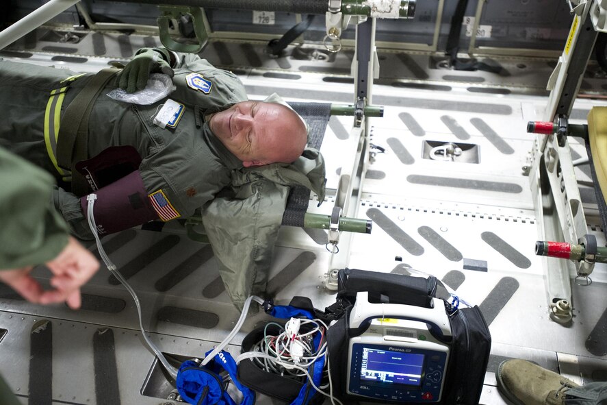 A patient receives treatment during an aeromedical evacuation training flight onboard a C-17 Globemaster III Saturday, Aug. 28, 2016.  More than a dozen 459th AES flight nurses, technicians and administrators flew to Peterson Air Force Base, Colorado, to conduct joint unit training with other AE squadrons on board the KC-135R Stratotanker, C-17 Globemaster III and C-130H3 Hercules. (U.S. Air Force photo/Staff Sgt. Kat Justen)