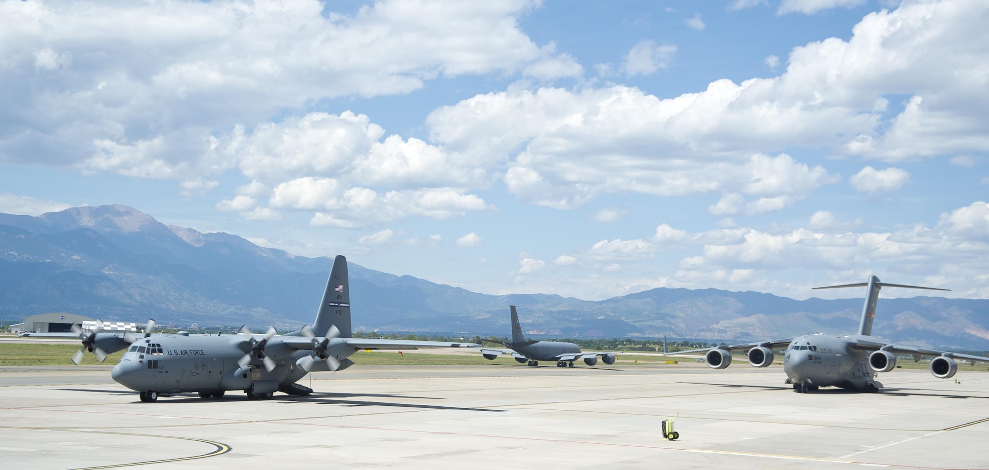A C-130H3 Hercules, KC-135R Stratotanker and C-17 Globemaster III rest on the Peterson Air Force Base, Colorado, flight line during round robin aeromedical evacuation training missions Saturday, Aug. 28, 2016. More than a dozen 459th AES flight nurses, technicians and administrators flew to Peterson to conduct joint unit training with other AE squadrons onboard the three aircraft. (U.S. Air Force photo/Staff Sgt. Kat Justen)