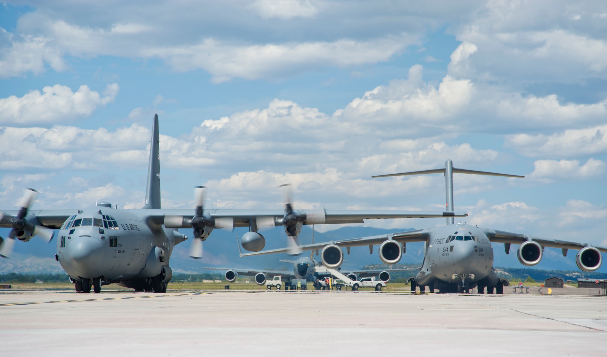 A C-130H3 Hercules, KC-135R Stratotanker and C-17 Globemaster III rest on the Peterson Air Force Base, Colorado, flight line during round robin aeromedical evacuation training missions Saturday, Aug. 28, 2016. More than a dozen 459th AES flight nurses, technicians and administrators flew to Peterson to conduct joint unit training with other AE squadrons onboard the three aircraft. (U.S. Air Force photo/Staff Sgt. Kat Justen)