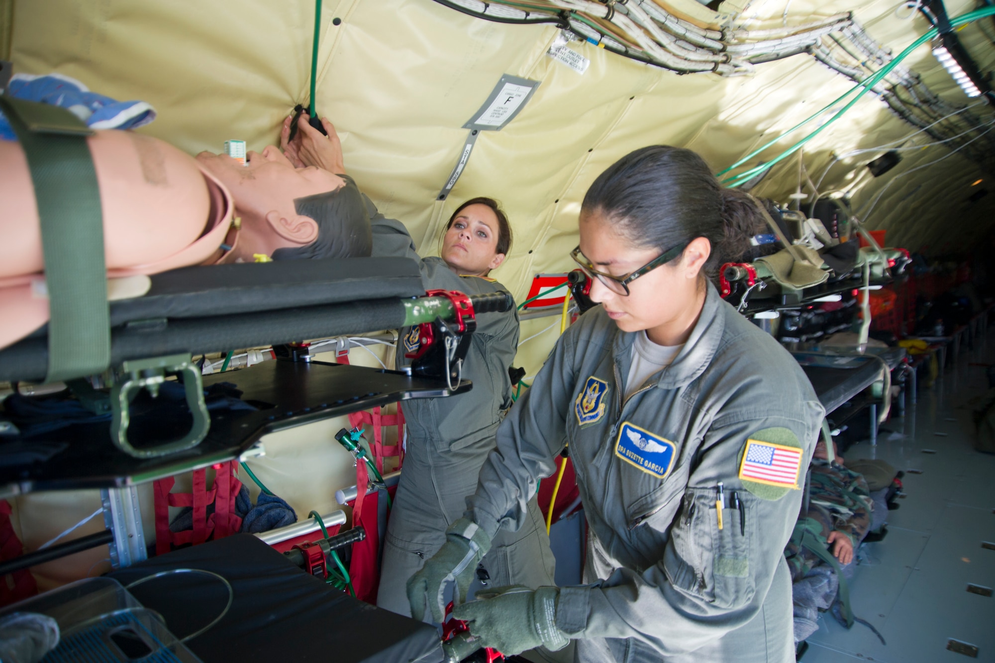 Members of the 459th Aeromedical Evacuation Squadron secure litters and oxygen lines prior to takeoff of a KC-135R Stratotanker on the Peterson Air Force Base, Colorado, flight line, Sunday, Aug. 28, 2016. More than a dozen 459th AES flight nurses, technicians and administrators flew to Peterson to conduct joint unit training with other AE squadrons on board the KC-135, C-17 Globemaster III and C-130H3 Hercules. (U.S. Air Force photo/Staff Sgt. Kat Justen)