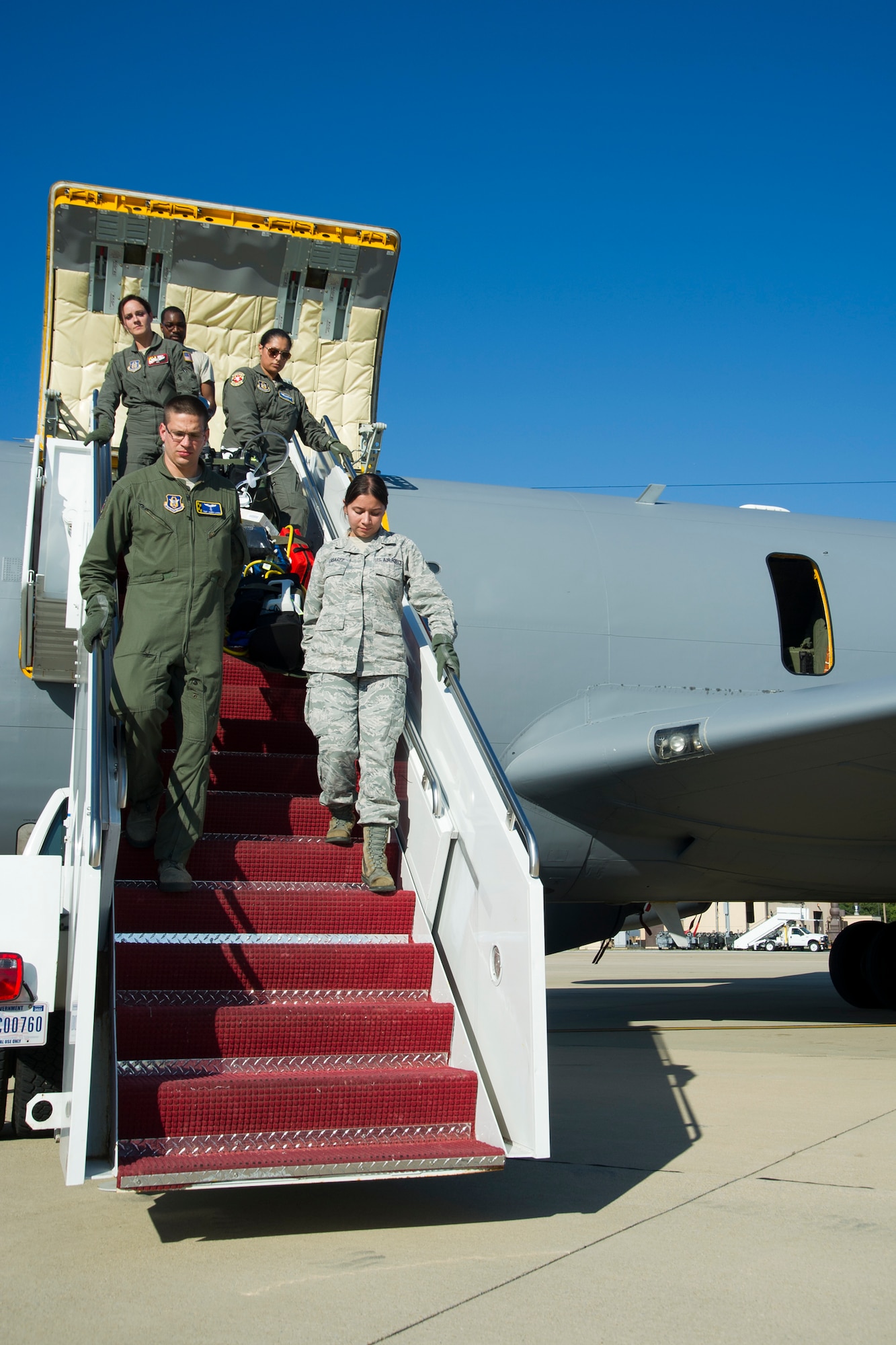 Members of 459th Aeromedical Evacuation Squadron disembark from a KC-135R Stratotanker on the Joint Base Andrews, Maryland, flight line Sunday, Aug. 28, 2016, upon return from joint-unit, multi-aircraft training at Peterson Air Force Base, Colorado. More than a dozen AES flight nurses, technicians and administrators flew to Peterson to conduct joint unit training with other AE squadrons on board the KC-135, C-17 Globemaster III and C-130H3 Hercules. Serving as a medical transport unit, the 459th AES trained for various medical conditions and situations. (U.S. Air Force photo/Staff Sgt. Kat Justen)