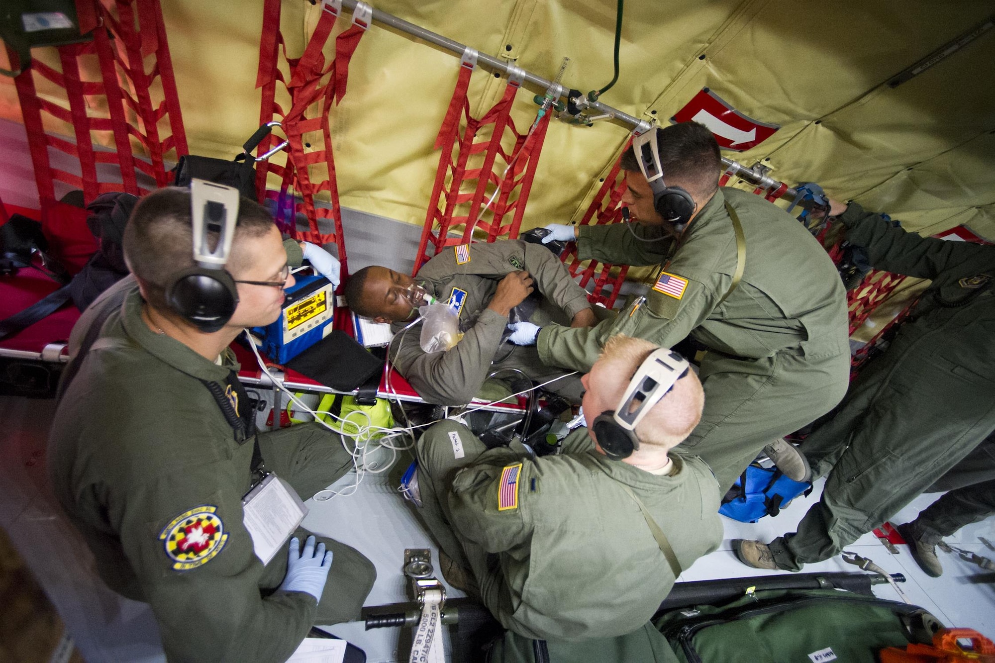 Members of the 459th Aeromedical Evacuation Squadron treat a seizure patient during an exercise onboard a KC-135R Stratotanker enroute from Joint Base Andrews, Maryland, to Peterson Air Force Base, Colorado, Friday, Aug. 26, 2016. More than a dozen AES flight nurses, technicians and administrators flew to Peterson to conduct joint unit training with other AE squadrons on board the KC-135, C-17 Globemaster III and C-130H3 Hercules. Serving as a medical transport unit, the 459th AES trained for various medical conditions and situations. (U.S. Air Force photo/Staff Sgt. Kat Justen)