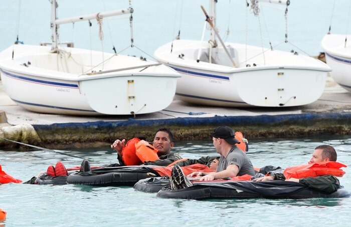 Tech. Sgt. Kevin Yamaguchi, crew chief, and Capt. Christopher Myers, logistics readiness officer, both with the 149th Fighter Wing, Texas Air National Guard, headquartered at Joint Base San Antonio-Lackland, Texas, practice survival techniques in a life raft taught by a survival, evasion, resistance, and escape (SERE) specialist with the 15th Wing at Joint Base Pearl Harbor-Hickam, Hawaii, Aug. 22, 2016. Yamaguchi and Myers Members were required to complete the training prior to getting a flight in the F-16 Fighting Falcon as part of the Sentry Aloha 2016, a large-scale fighter exercise hosted by the Hawaii Air National Guard. 