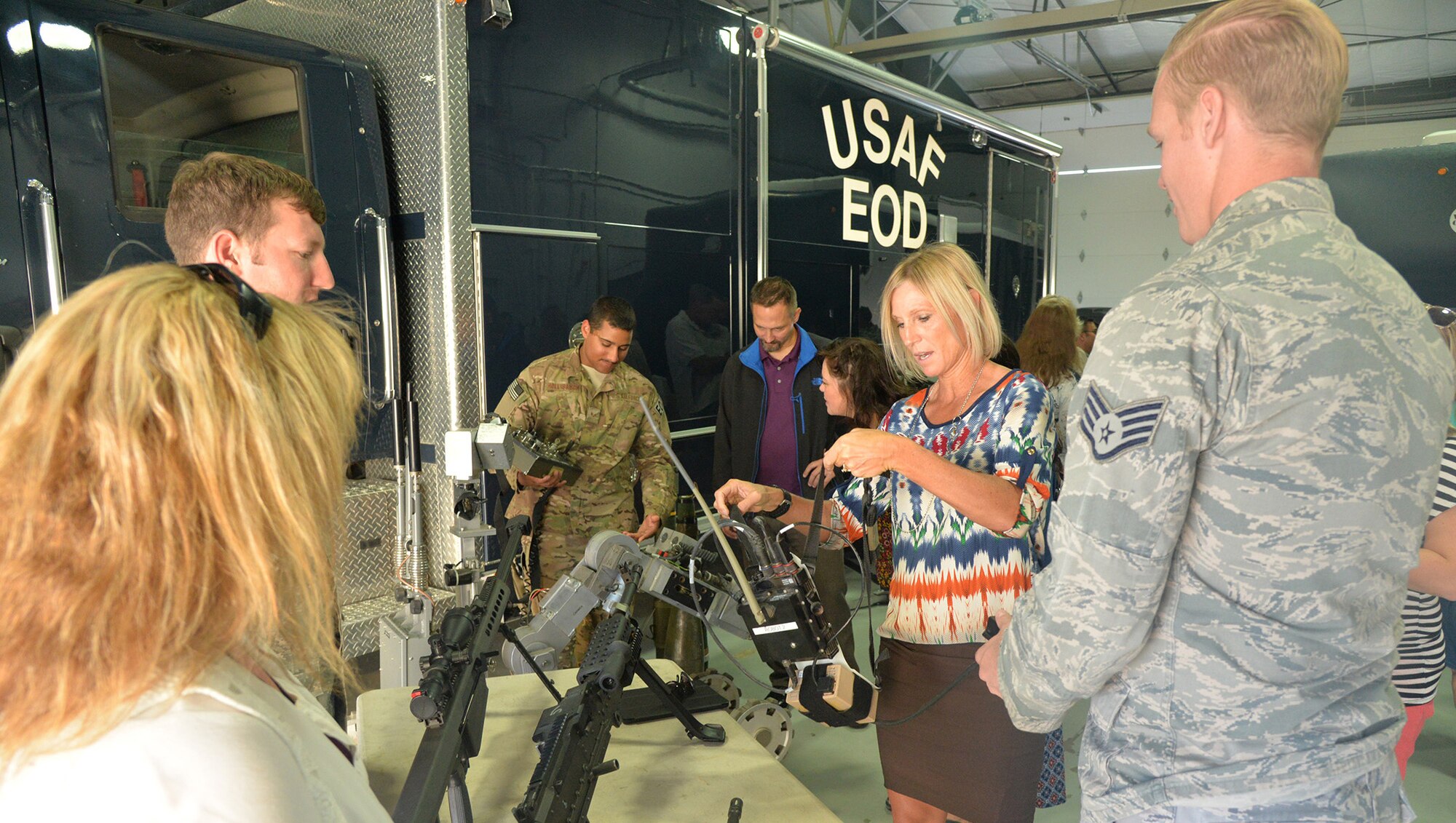 Kim Ray, Loy Elementary School principal, handles 341st Civil Engineer Squadron Explosive Ordnance Disposal equipment during a base tour Aug. 29, 2016, at Malmstrom Air Force Base, Mont. The EOD team gave the school staff insight into their mission and service to Montana as responders when assisting with the disposal of explosives found throughout the state. (U.S. Air Force photo/Airman 1st Class Daniel Brosam)