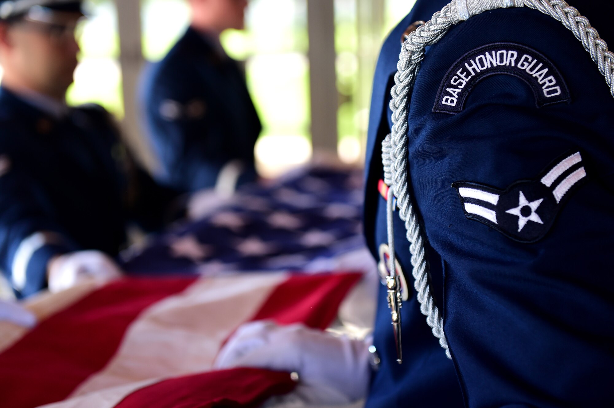 U.S. Air Force Mile High Honor Guard members fold a flag during a funeral August 30, 2016, at Fort Logan National Cemetery, Colo. The Honor Guard represents the Air Force in many ceremonial functions including funerals, changes of command and retirements. (U.S. Air Force photo by Airman 1st Class Gabrielle Spradling/Released)