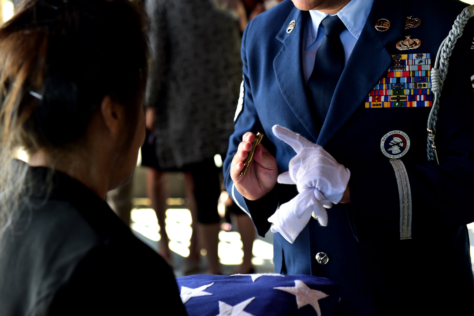 Master Sgt. Wolfram Stumpf, U.S. Air Force Mile High Honor Guard presents a widow the shells from the three volley rifle salute during the funeral for her husband August 30, 2016, at Fort Logan National Cemetery, Colo. Honor Guard members strive to ensure a legacy of Airmen who promote the mission, protect the standards, perfect the image and preserve the heritage of the organization. (U.S. Air Force photo by Airman 1st Class Gabrielle Spradling/Released)
