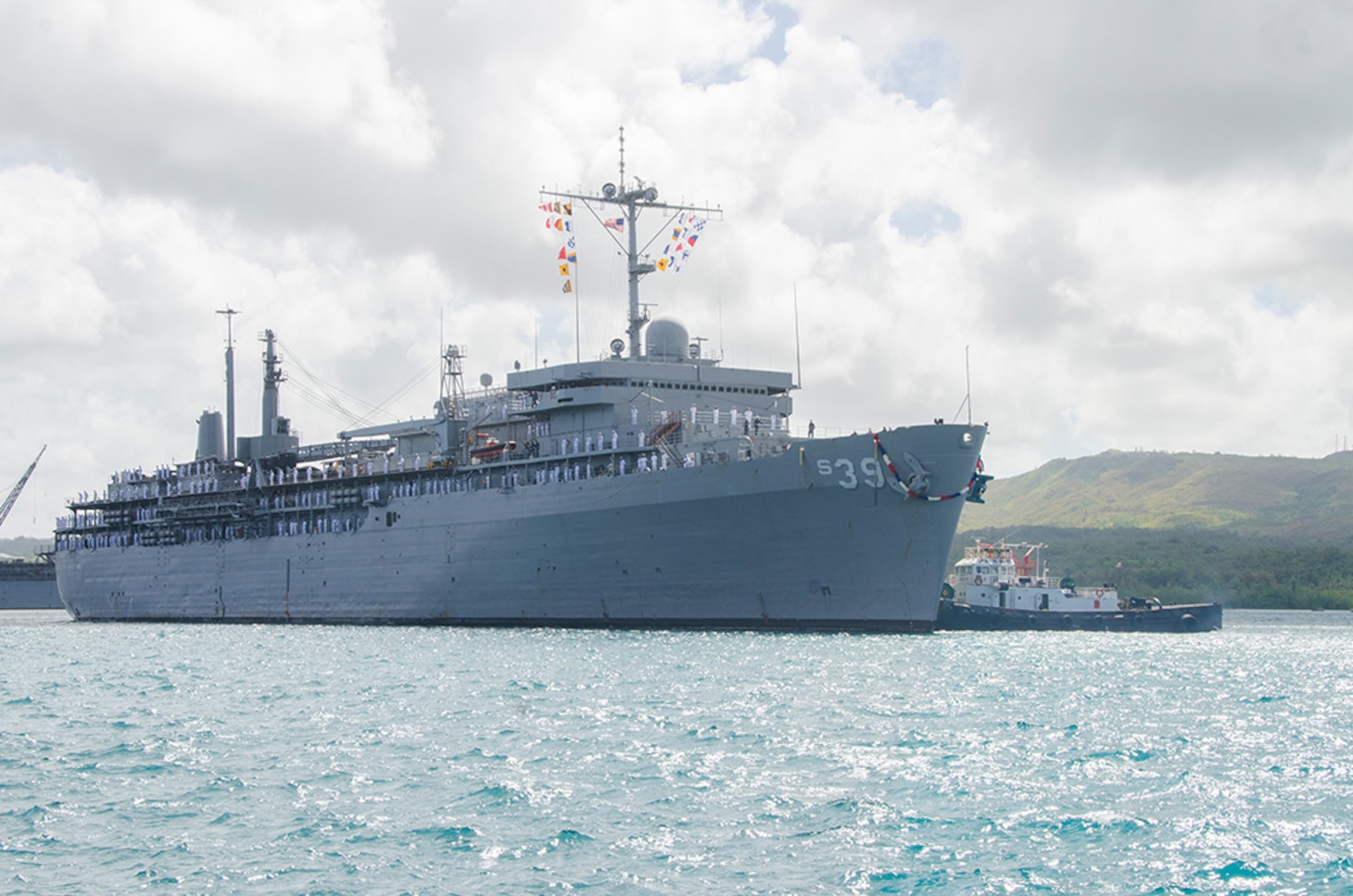 Sailors aboard the submarine tender USS Emory S. Land (AS 39) man the rails as the ship returns from deployment, April 11, 2016.   The return to Guam is Emory S. Land's first, since changing homeport from Diego Garcia to Guam Dec. 23. Emory S. Land is an expeditionary submarine tender conducting coordinated tended moorings and afloat maintenance in the U.S. 5th and 7th Fleet areas of operations.