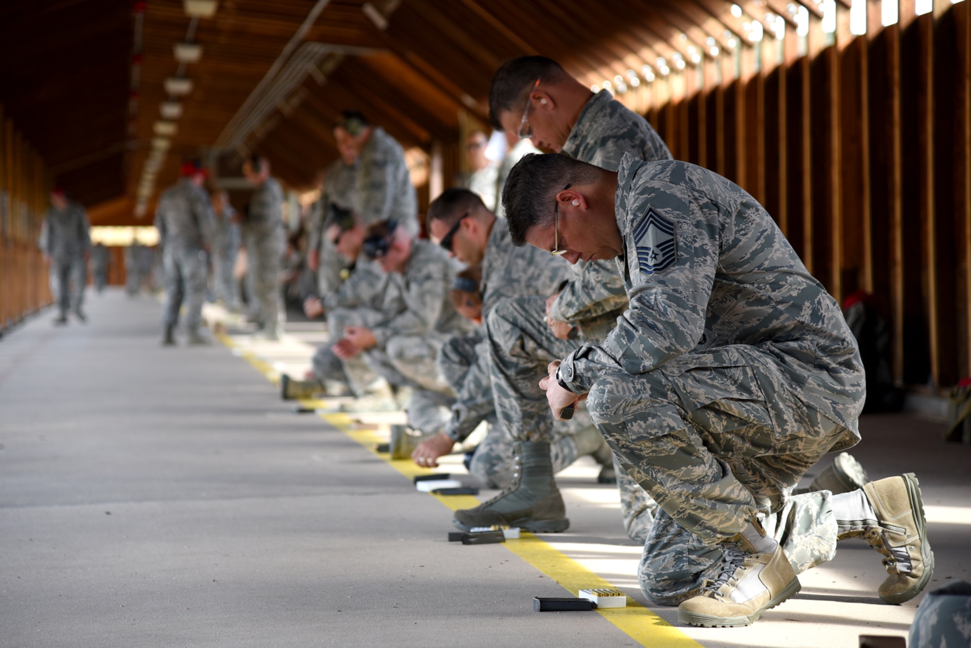 Chief Master Sgt. Shadd McKee, 10th Security Forces Squadron security force manager, loads the M9 pistol used in the competition at the combat arms firing range at the United States Air Force Academy, Colo., Aug. 22, 2016. The competition was open to all Front Range active duty and reserve Air Force personnel, regardless of Air Force specialty code. (U.S. Air Force photo by Airman 1st Class Dennis Hoffman)