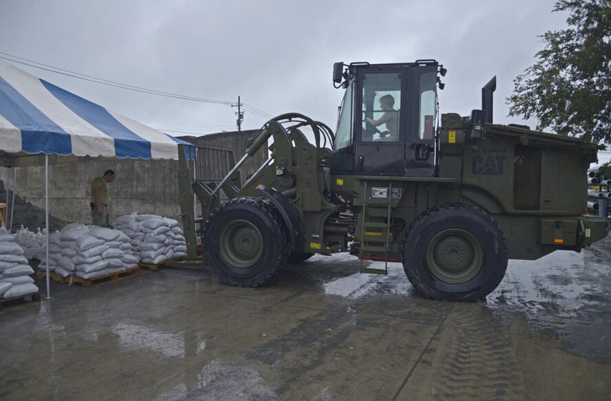 Senior Airman Megan Tubridy, 374th Civil Engineer Squadron structures journeyman, prepares to move sand bags using a forklift at Yokota Air Base, Japan, Aug. 27, 2016. Airmen helped assemble 5,000 sand bags in preparation for potential flooding. One week earlier, Typhoon Mindulle dropped nearly 10 inches of rain and heavy winds on Yokota, flooding many buildings and causing power outages for nearly 1,000 base residents.  (U.S. Air Force photo by Senior Airman David Owsianka/Released)