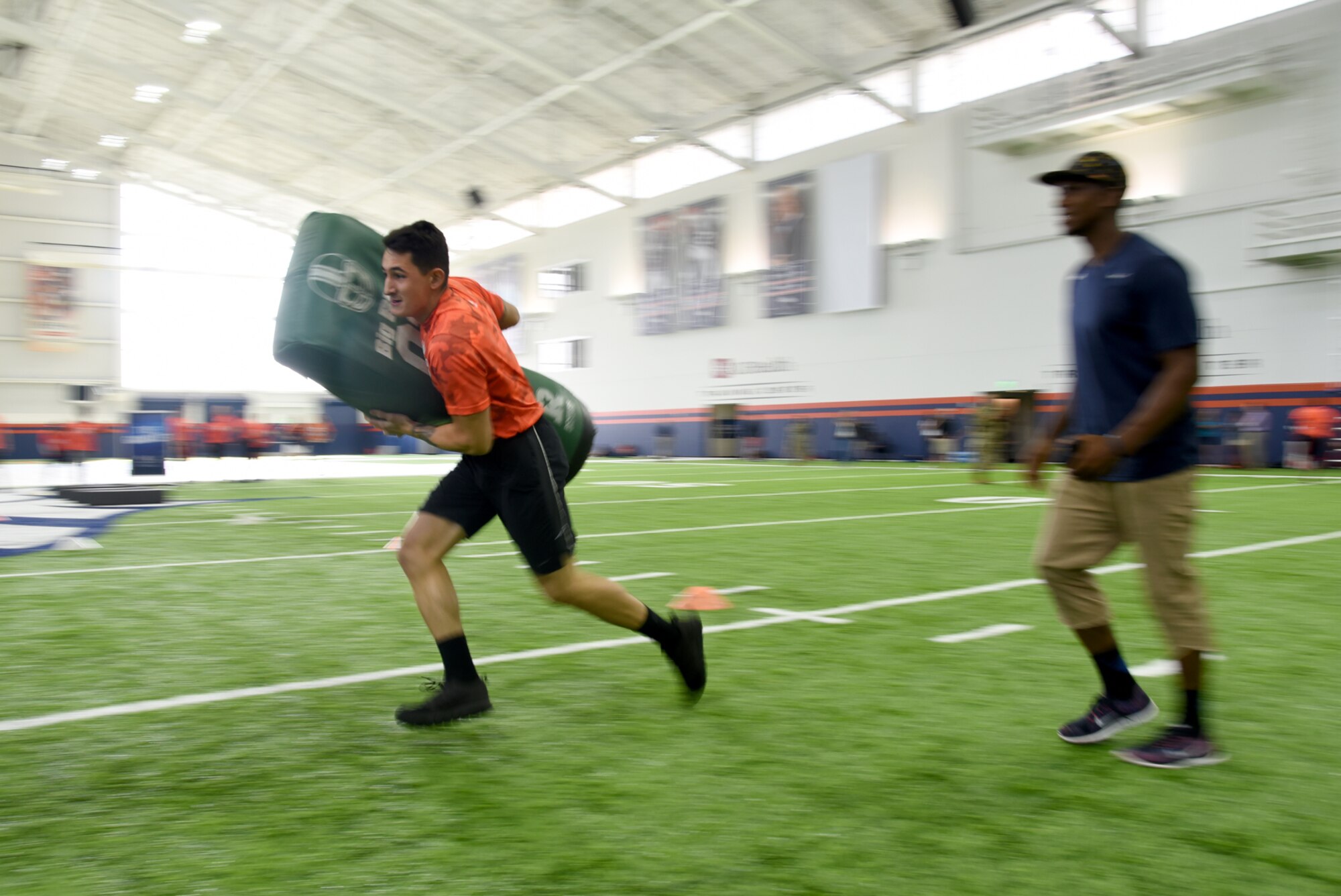 ENGLEWOOD, Colo. – Airman 1st Class Tristen Hearld, 21st Medical Support Squadron pharmacy technician, competes in one of five different football drills similar to those used to evaluate NFL talent in an NFL boot camp at Denver Broncos UCHealth Training Center Fieldhouse, Denver, Colo., Aug. 25, 2016. Team Pete Airmen and service members across Colorado gathered to take part in the NFL boot camp. (U.S. Air Force photo by Airman 1st Class Dennis Hoffman)