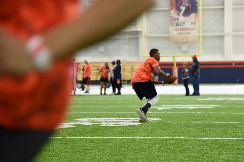 ENGLEWOOD, Colo. – Airman 1st Class Ceron Cherry, 21st Force Support Squadron career development journeyman, competes in one of five different football drills similar to those used to evaluate NFL talent in an NFL boot camp at Denver Broncos UCHealth Training Center Fieldhouse, Denver, Colo., Aug. 25, 2016. Team Pete Airmen and service members across Colorado gathered to take part in the NFL boot camp. (U.S. Air Force photo by Airman 1st Class Dennis Hoffman)