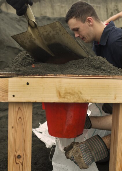 Airmen fill sandbags in preparation for Typhoon Lionrock at Yokota Air Base, Japan, Aug. 27, 2016. The Airmen helped fill approximately 5,000 sand bags in preparation for the typhoon. One week earlier, Typhoon Mindulle dropped nearly 10 inches of rain and heavy winds on Yokota, flooding many buildings and causing power outages for nearly 1,000 base residents. (U.S. Air Force photo by Airman 1st Class Donald Hudson/Released)