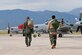 An Afghanistan Air Force pilot, right, joins his trainer for a morning sortie of high-density altitude training in an A-29 Super Tucano at Peterson Air Force Base, Colo., Aug. 24, 2016. The Afghan Air Force is participating in a program training 30 pilots and 90 maintainers for the aircraft, which will be used mainly for close air support functions. (U.S. Air Force photo/Airman 1st Class Dennis Hoffman)