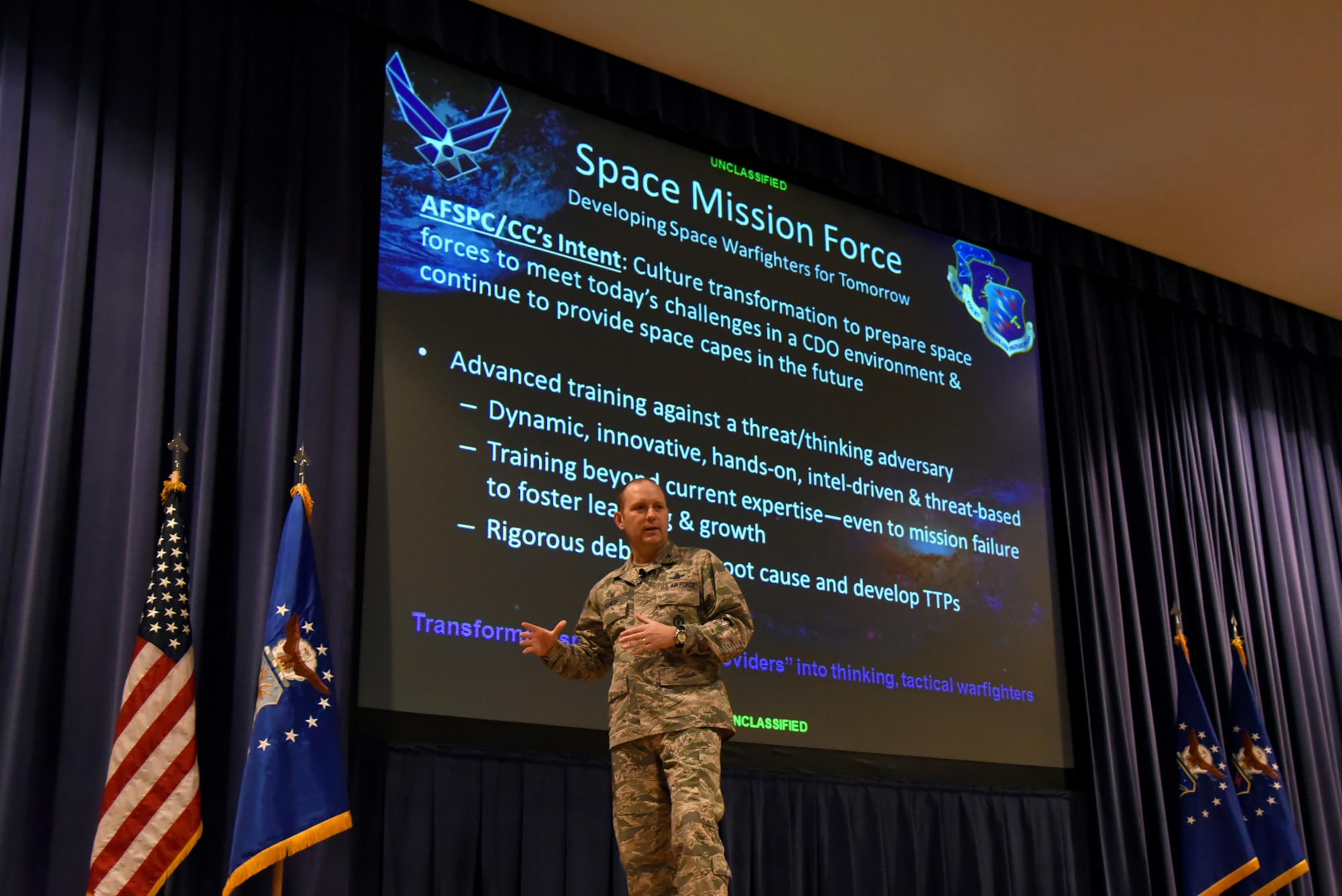 PETERSON AIR FORCE BASE, Colo. – Col. Doug Schiess, 21st Space Wing commander, addresses wing personnel at an all call at Peterson Air Force Base, Colo., Aug. 23, 2016. Schiess focused on efforts of Airmen and how the wing continues to rise to any occasion, no matter the challenge facing them.  (U.S. Air Force photo by Airman 1st Class Dennis Hoffman)