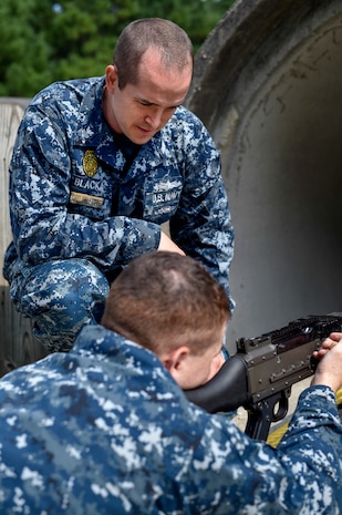 Chief Petty Officer Selectee Joseph Blacka, a 628th Security Forces Harbor Security Department Master-at-Arms leading petty officer, teaches sailors about weapons at Joint Base Charleston, South Carolina, Aug. 23, 2016. (U.S. Air Force Photo/Airman Megan Munoz)