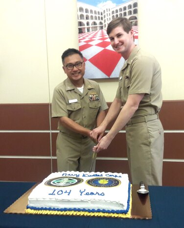 Capt. John Leung (left), senior dental executive, Naval Health Clinic Charleston and Lt. Samuel Joyner, NHCC dentist, cut the cake during a ceremony celebrating the Navy Dental Corps' 104th birthday Aug. 22, 2016 at NHCC's Dental Clinic. (Navy photo by Seaman Kellen Kloss)