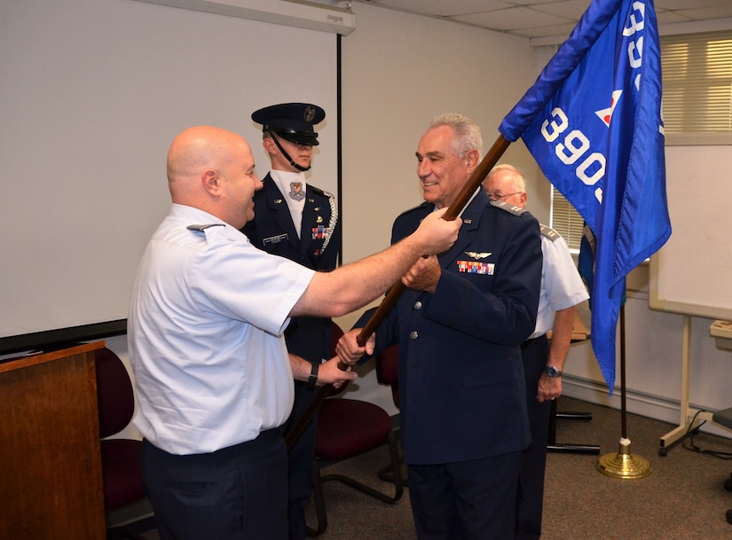 Civil Air Patrol's Coastal Charleston Squadron welcomes a new commander as Capt. Jim Greco accepts the squadron flag from South Carolina wing commander, Col. Francis Smith, August 15, 2016, at Joint Base Charleston, South Carolina. Assisting in the ceremony is Cadet Col. Tyler Hoover (center). (Courtesy photo)