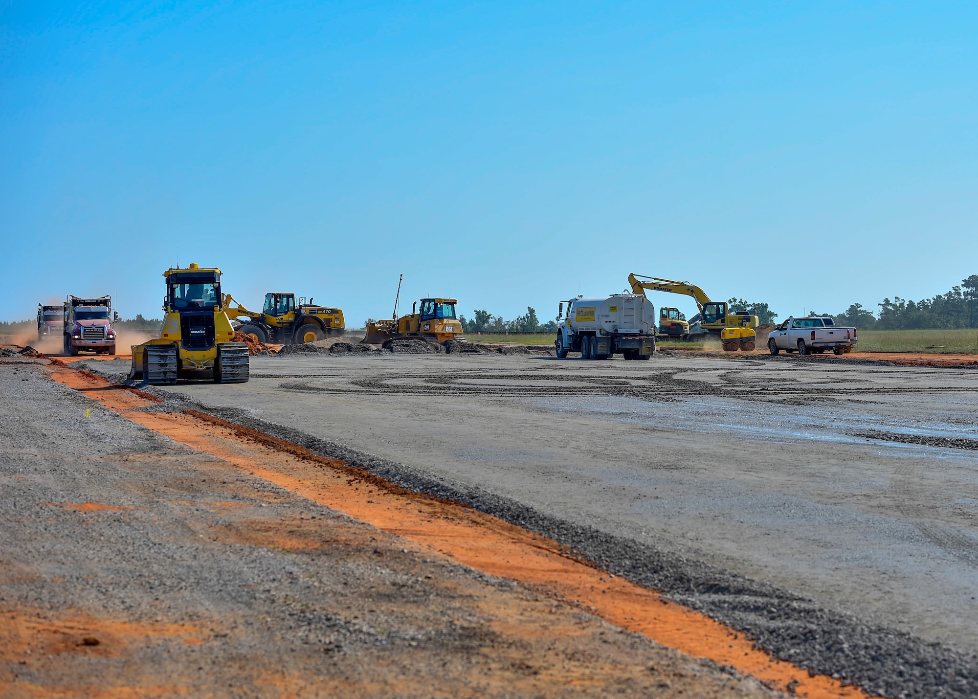 A stone base layer is put down by construction workers with R.C. Construction Company for a new landing zone at the North Auxiliary Airfield in North, South Carolina, Aug. 25, 2016. The airfield directly supports the 437th and 315th Airlift Wing's C-17 Globemaster III aircrew training and proficiency training. (U.S. Air Force Photo/Airman Megan Munoz)