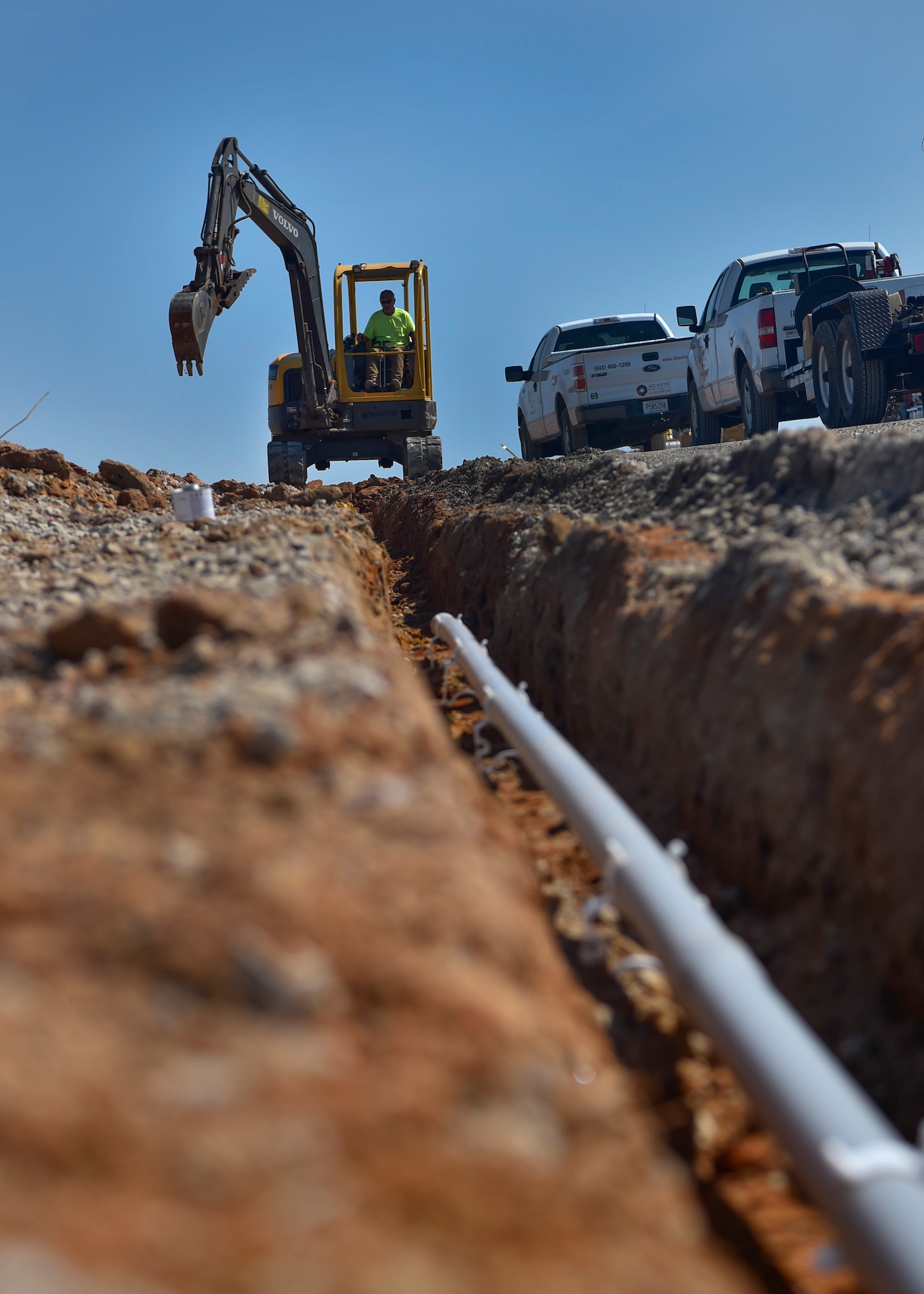A construction worker with Atlantic Electric LLC digs a trench for a pipe at the North Auxiliary Airfield in North, South Carolina, Aug. 25, 2016. The airfield directly supports the 437th and 315th Airlift Wing's C-17 Globemaster III aircrew training and proficiency training. (U.S. Air Force Photo/Airman Megan Munoz)
 