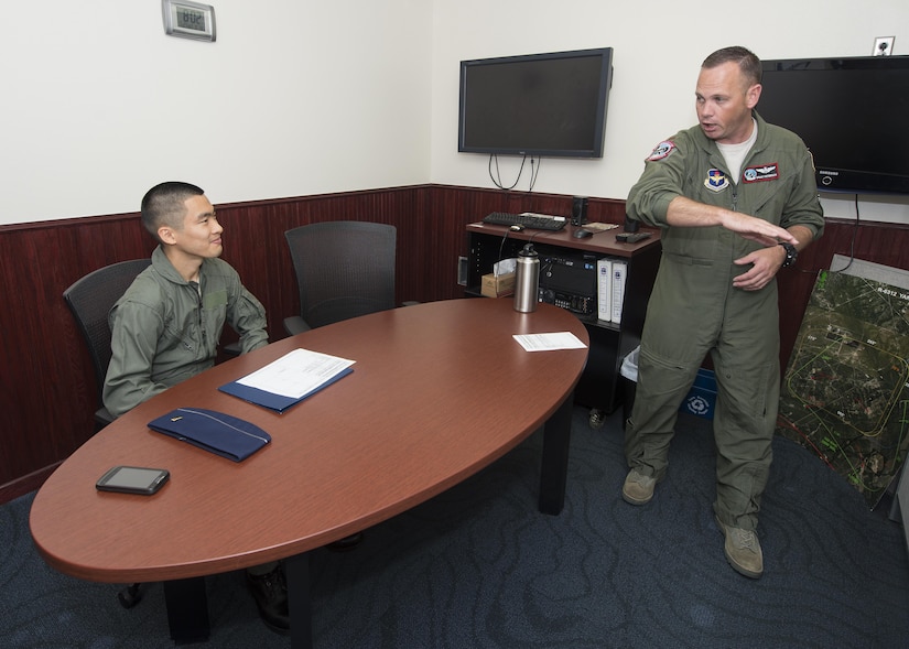 Maj. Gavin Peterson, 435th Fighter Training Squadron flight commander, gives a safety brief before an incentive flight to 2nd Lt. Chris Hsu, Air Education and Training Judge Advocate legal intern, at Joint Base San Antonio-Randolph July 27, 2016. Incentive flights are offered within the Air Force to reward individuals for exemplary performance. 