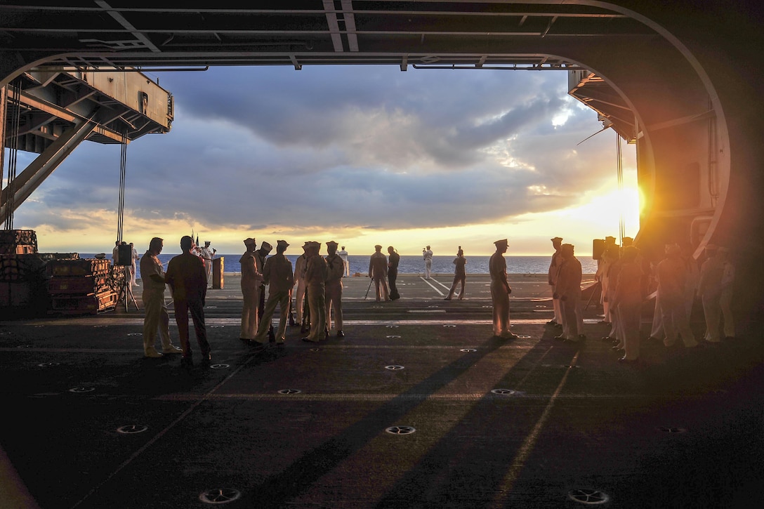 Sailors prepare to assist with a burial-at-sea ceremony aboard the aircraft carrier USS George Washington in the Atlantic Ocean, Aug. 27, 2016. The George Washington is underway conducting carrier qualifications. Navy photo by Petty Officer 2nd Class Kris R. Lindstrom