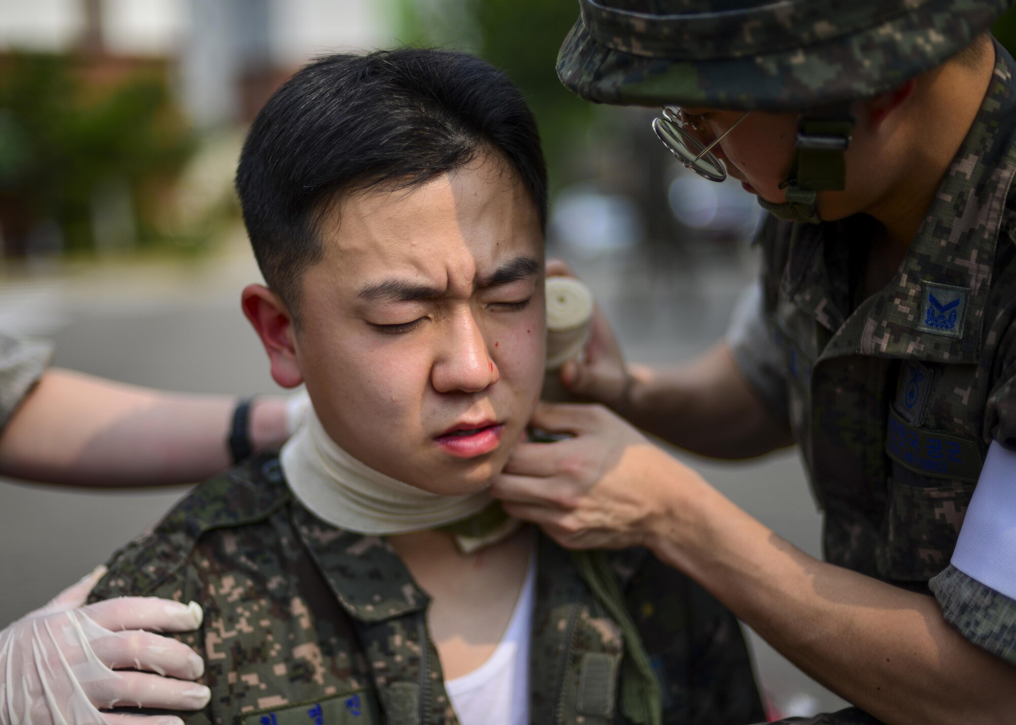 A Republic of Korea air force airman is treated for a simulated neck injury during a joint mass-casualty medical exercise at Osan Air Base, Republic of Korea, Aug. 22, 2016. ROKAF medical personnel worked with 51st Medical Group medics on triaging and transporting victims of a simulated bombing to proper medical facilities. (U.S. Air Force photo by Senior Airman Victor J. Caputo)
