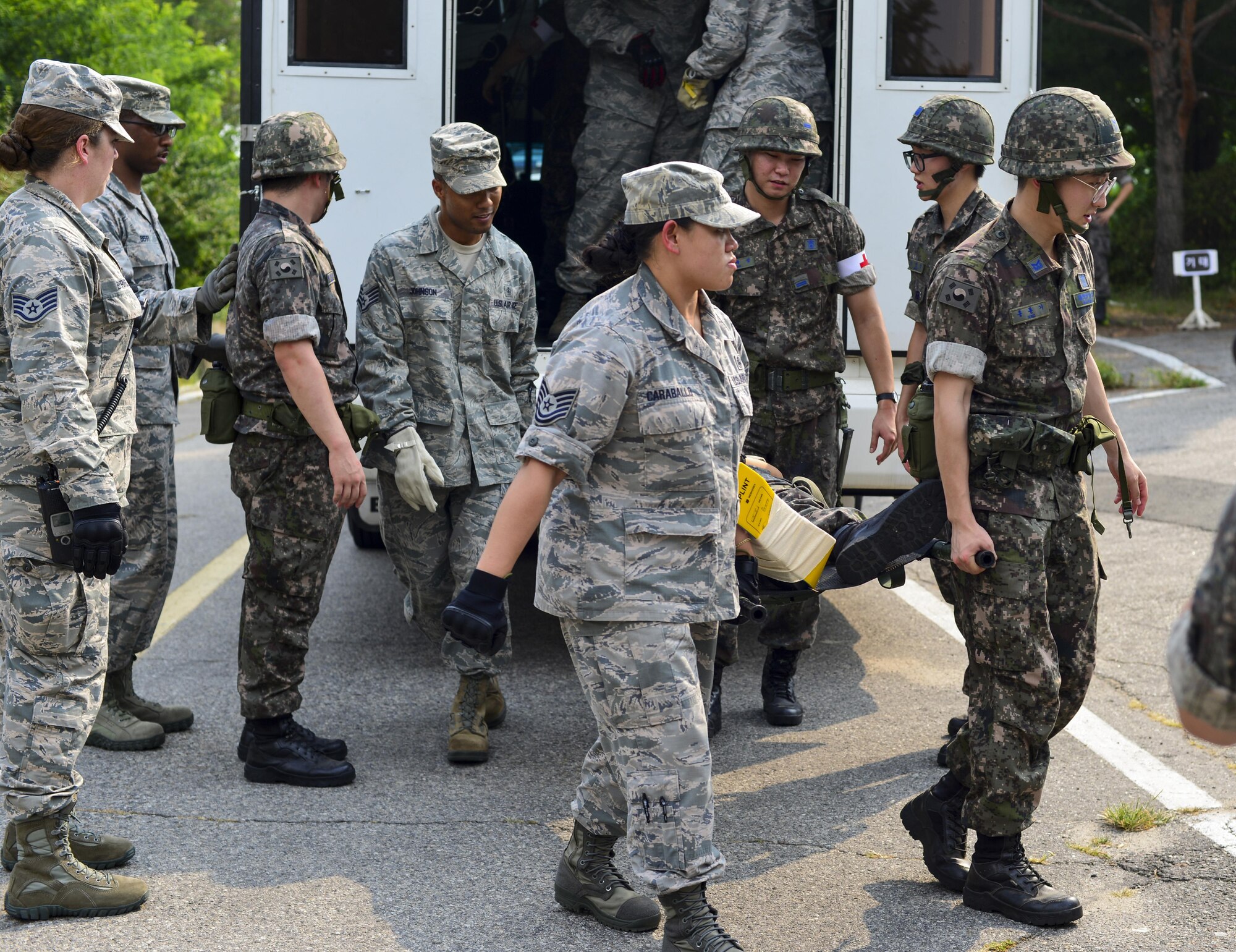 Medics from the 51st Medical Group and Republic of Korea air force transport a simulated bombing victim on a stretcher during a joint mass-casualty medical exercise at Osan Air Base, Republic of Korea. ROKAF medical personnel worked with the 51st MDG to understand the differences in how the U.S. Air Force triages and transports patients. (U.S. Air Force photo by Senior Airman Victor J. Caputo)