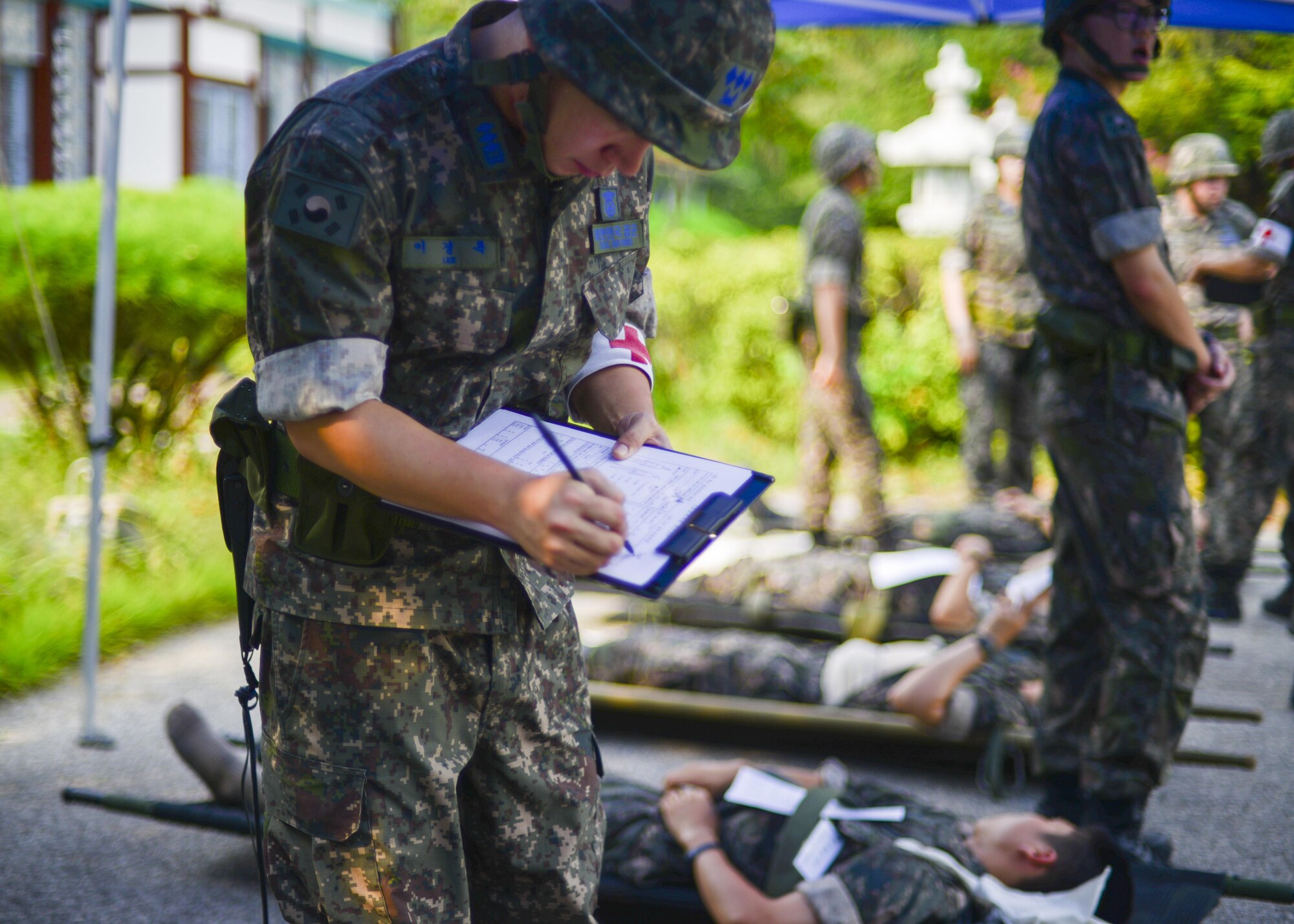 A Republic of Korea air force doctor fills out a victim-identifier form on the victim of a simulated bombing during a joint mass-casualty medical exercise at Osan Air Base, Republic of Korea, Aug. 22, 2016. ROKAF medical personnel worked with 51st Medical Group personnel on triaging and transportation procedures during the exercise. (U.S. Air Force photo by Senior Airman Victor J. Caputo)