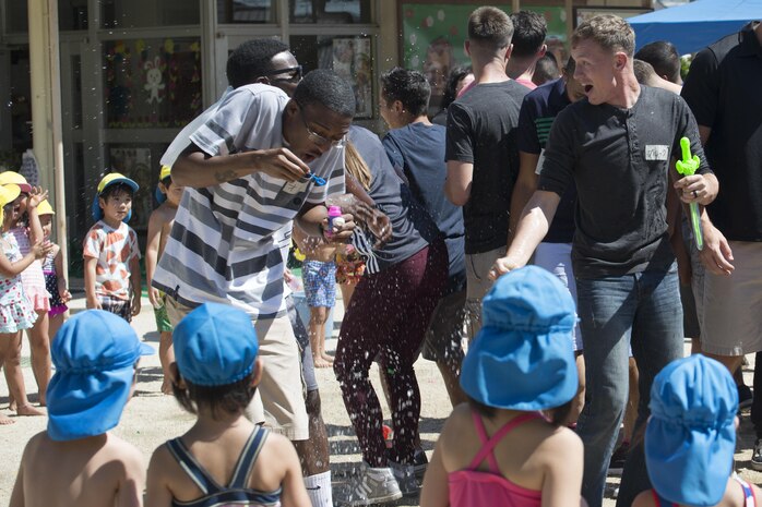 Volunteers with the Marine Memorial Chapel dodge water balloons during a water fight at Midoro Hoikuen in Iwakuni, Japan, Aug. 23, 2016. Local Japanese preschoolers enjoyed a day of fun filled activities as part of a community relations preschool visit between Marine Corps Air Station Iwakuni and the local community. (U.S. Marine Corps photo by Lance Cpl. Joseph Abrego)