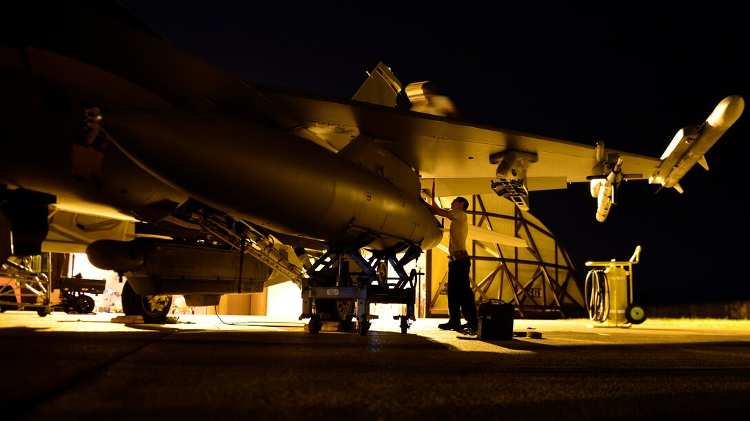 Staff Sgt. Walter Rueda-Perez, 31st Aircraft Maintenance Squadron dedicated crew chief, tightens a bolt on a fuel tank during swing shift, Aug. 24, 2016 at Aviano Air Base, Italy. Swing shift maintenance teams provide necessary repairs from electrical to mechanical inside and outside the aircraft to ensure mission readiness for the following day. (U.S. Air Force photo by Airman 1st Class Cary Smith/Released)