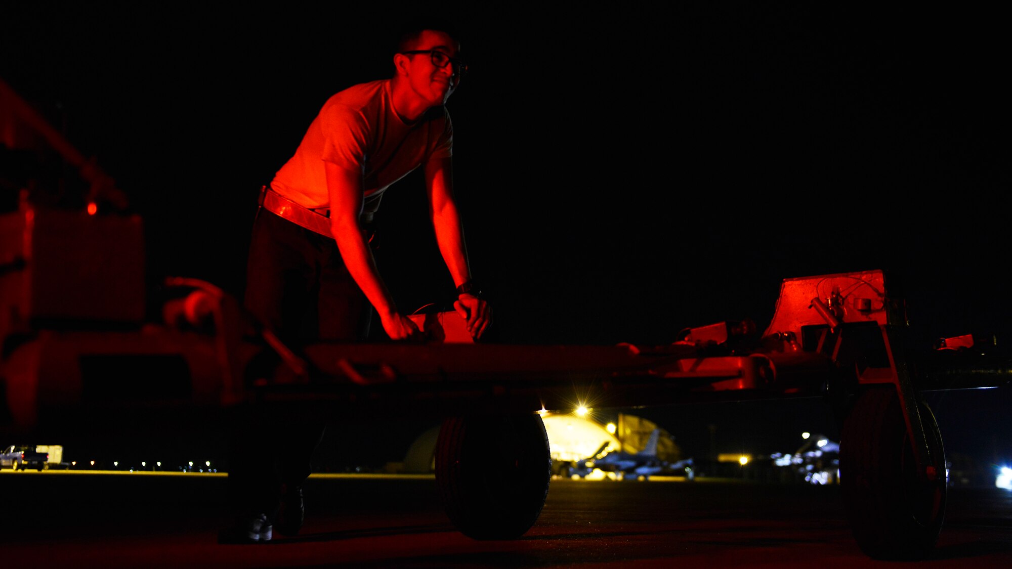 Staff Sgt. Walter Rueda-Perez, 31st Aircraft Maintenance Squadron dedicated crew chief, attaches a fuel tank trailer to a truck, Aug. 24, 2016 at Aviano Air Base, Italy. The swing shift maintenance is comprised of teams who work together overnight on various maintenance tasks. (U.S. Air Force photo by Airman 1st Class Cary Smith/Released)