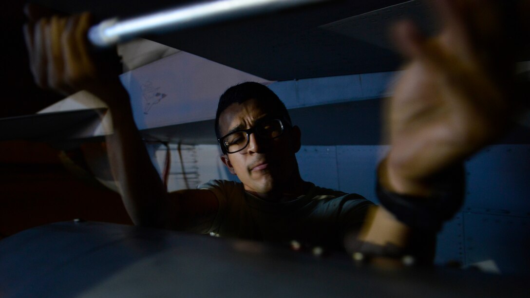 Staff Sgt. Walter Rueda-Perez, 31st Aircraft Maintenance Squadron dedicated crew chief, loosens a bolt on a fuel tank, Aug. 24, 2016 at Aviano Air Base, Italy. The maintenance team swapped fuel tanks on several F-16 Fighting Falcons to meet maintenance standards and ensure mission readiness. (U.S. Air Force photo by Airman 1st Class Cary Smith/Released)
