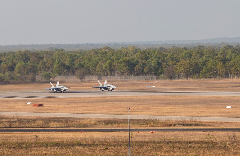 Two F/A-18C Hornets with Marine Fighter Attack Squadron (VMFA) 122 prepare for takeoff during Southern Frontier at Royal Australian Air Force Base Tindal, Australia, Aug. 31, 2016. The Hornet squadron performed low-altitude tactics training throughout the last week of training, allowing the pilots to gain confidence in low flying and simultaneously conducting air-to-surface maneuvers. Southern Frontier is a three week unit level training helping pilots gain experience and qualifications in low-altitude tactics, close air support, and air ground, high explosive ordnance delivery. (U.S. Marine Corps photo by Cpl. Nicole Zurbrugg) 