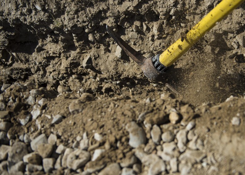 Electricians from the 455th Expeditionary Civil Engineer Squadron dig a pipe line trench to lay service wire, Bagram Airfield, Afghanistan, Aug. 31, 2016. The wiring will be used to provide electricity to a new Airman’s Ministry Center and Airman’s Attic. (U.S. Air Force photo by Senior Airman Justyn M. Freeman)