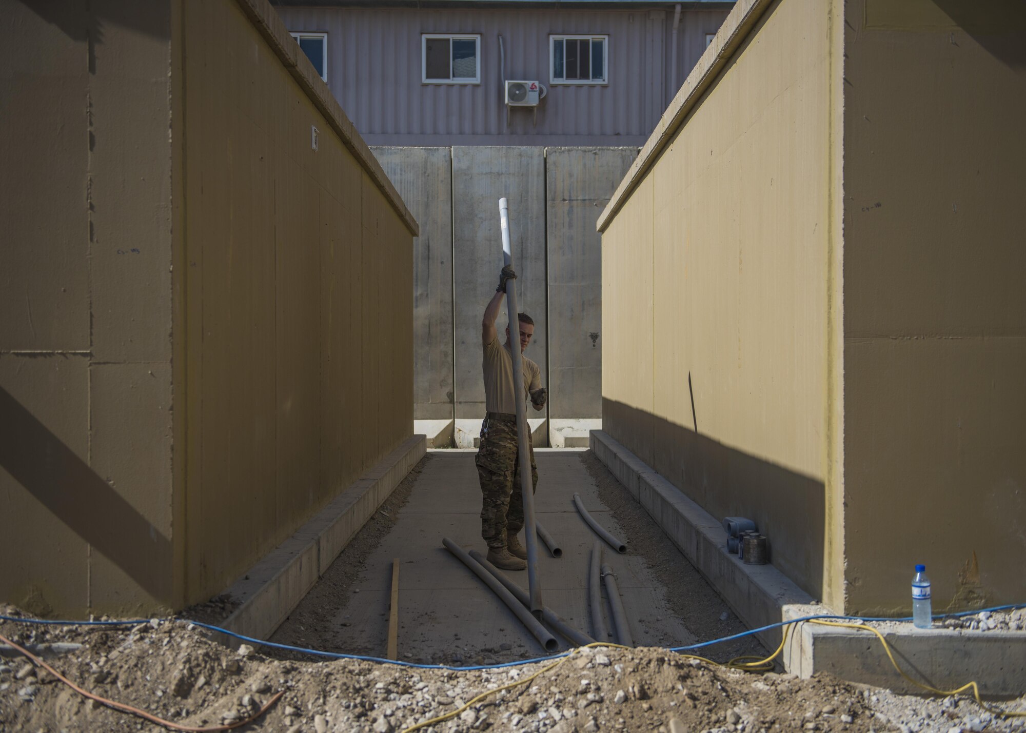 Staff Sgt. Colin Cardwell, 455th Expeditionary Civil Engineer Squadron electrical journeyman, measures out polyvinyl chloride (PVC) to construct piping for electrical wiring, Bagram Airfield, Afghanistan, Aug. 31, 2016. PVC protects underground wiring from environmental elements. (U.S. Air Force photo by Senior Airman Justyn M. Freeman)