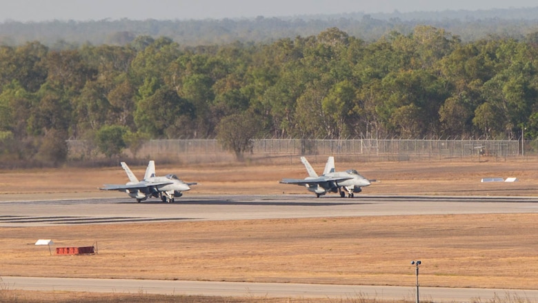 Two F/A-18C Hornets with Marine Fighter Attack Squadron (VMFA) 122 prepare for takeoff during Southern Frontier at Royal Australian Air Force Base Tindal, Australia, Aug. 31, 2016. The Hornet squadron performed low-altitude tactics training throughout the last week of training, allowing the pilots to gain confidence in low flying and simultaneously conducting air-to-surface maneuvers. Southern Frontier is a three week unit level training helping pilots gain experience and qualifications in low-altitude tactics, close air support, and air ground, high explosive ordnance delivery. 
