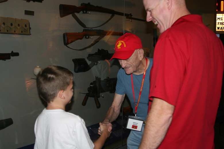 World War II Marine veteran Arnold Meads, 96, greets a 9-year-old fan at the National Museum of the Marine Corps Aug. 25.