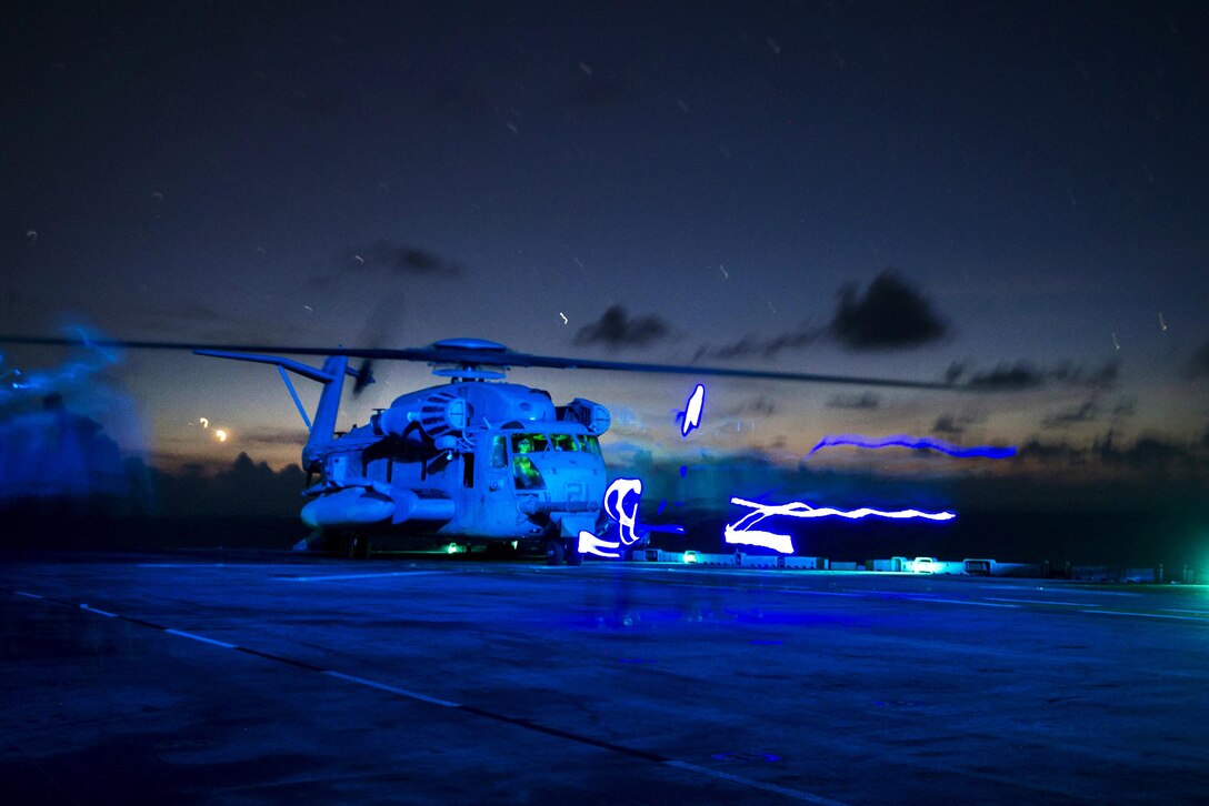 A CH-53E Super Stallion helicopter prepares to take off from the flight deck of the amphibious assault ship USS Boxer in the Pacific Ocean, Aug. 26, 2016. The helicopter crew is assigned to the 13th Marine Expeditionary Unit. Navy photo by Petty Officer 3rd Class Michael T. Eckelbecker