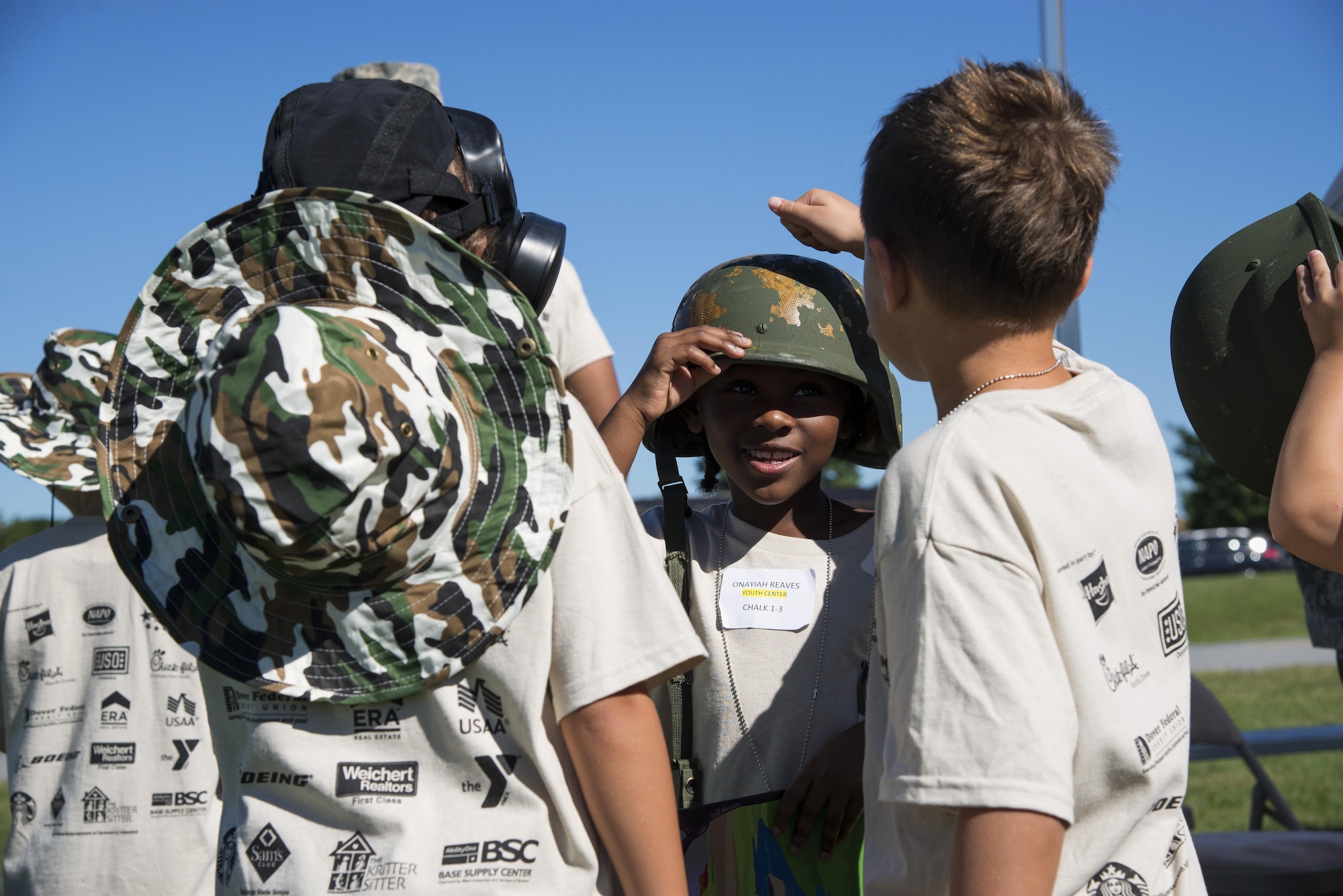 Onayiah Reaves, 6, daughter of Staff Sgt. Ebony Bates, 436th Medical Group command support staff, tests a helmet during the annual Kids/Teachers Understanding Deployment Operations event Aug. 23, 2016, at Dover Air Force Base, Del. The event introduced children of military members to the parts of a deployment. (U.S. Air Force photo by Senior Airman Aaron J. Jenne)
