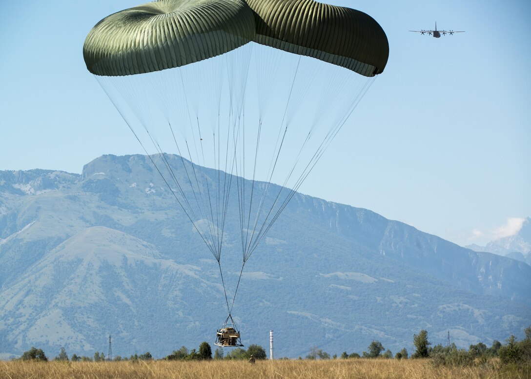 Equipment parachutes from a C-130 Hercules during a joint airborne operation near Aviano Air Base, Italy, Aug. 24, 2016. Paratroopers from the U.S. Army 173rd Airborne Brigade and German Army 1st Airborne Brigade paratroopers jumped shortly after. (U.S. Air Force photo by Airman 1st Class Cory W. Bush/Released)
