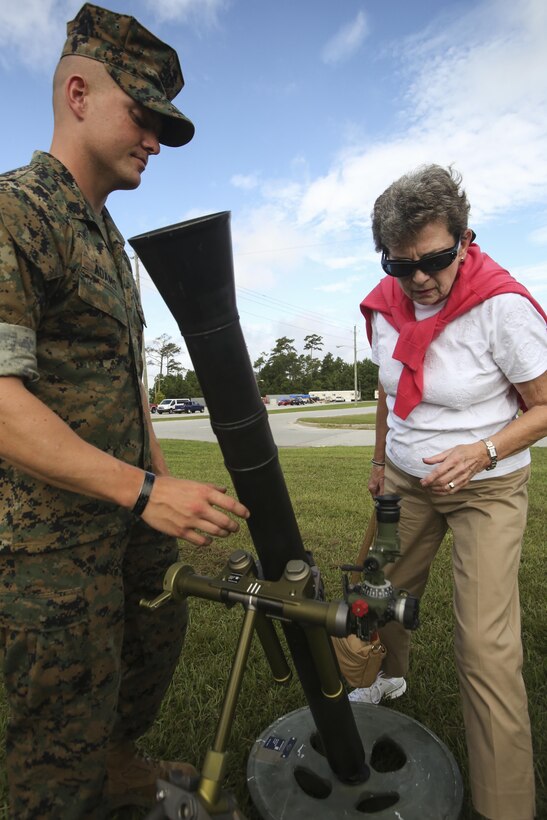A Marine with 2nd Battalion, 6th Marine Regiment, 2nd Marine Division explains how the a weapon works to a family member of a 1st Bn, 6th Marine veteran, visiting at Camp Lejeune, N.C., Aug. 29, 2016. 1/6 organized a reunion for the survivors of a helicopter crash involving 1/6 while they were attached to the 22nd Marine Expeditionary Unit in 1986.  (U.S. Marine Corps photo by Lance Cpl. Miranda Faughn)