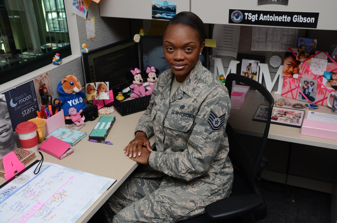Air Force Tech. Sgt. Antoinette Gibson is surrounded by photos and other items that remind her of her two daughters in her cubicle Aug. 24, 2016, at the Defense Information School on Fort Meade. Gibson, an instructor in the Basic Photojournalist Course-USAF, was selected as the school’s Warrior of the Quarter for the second quarter of 2016.