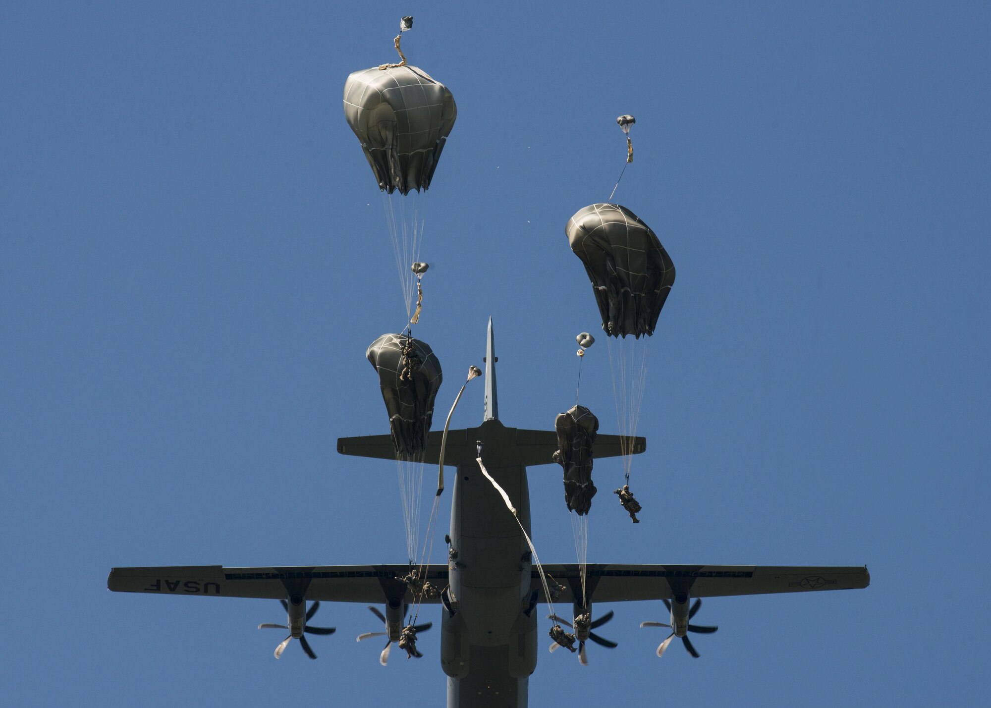 U.S. Army 173rd Airborne Brigade and German Army 1st Airborne Brigade paratroopers jump out of a C-130 Hercules near Aviano Air Base, Italy, Aug. 25, 2016. The paratroopers trained on airfield clearance after jumping out of a C-130 Hercules from the 86th Airlift Wing, Ramstein Air Base, Germany after departing from Aviano. (U.S. Air Force photo by Senior Airman Krystal Ardrey/Released)