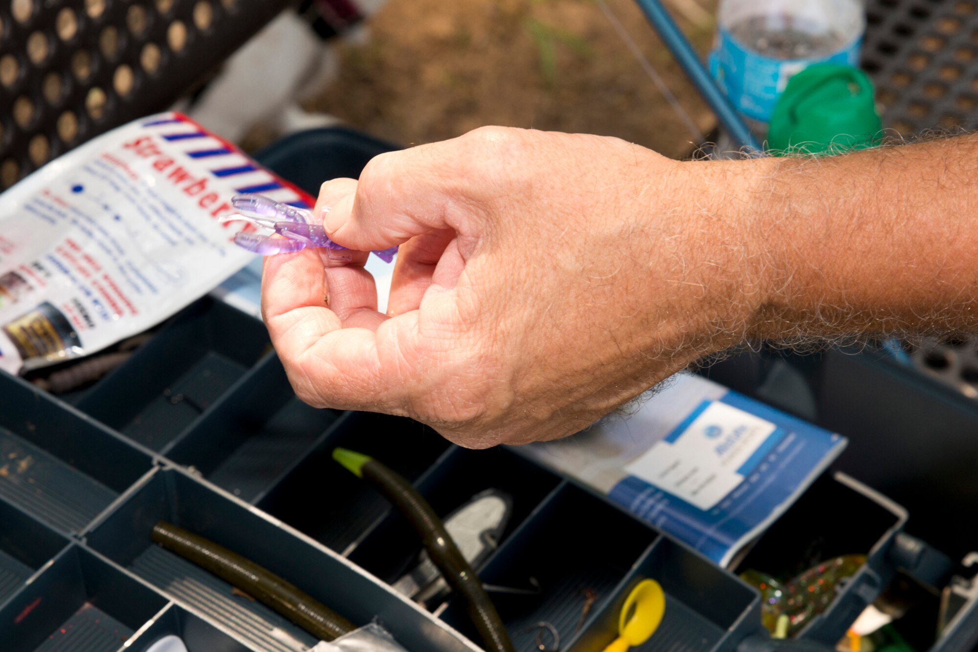Retired U.S. Army Sgt. 1st Class Kevin Delong chooses a new bait while fishing at Kenneth “Pat” Wilson Lake on Little Rock Air Force Base, Ark., Aug. 30, 2016. Fishing is just one of the many recreational activities available to residents and visitors at Little Rock AFB. (U.S. Air Force photo by Master Sgt. Jeff Walston/Released)  