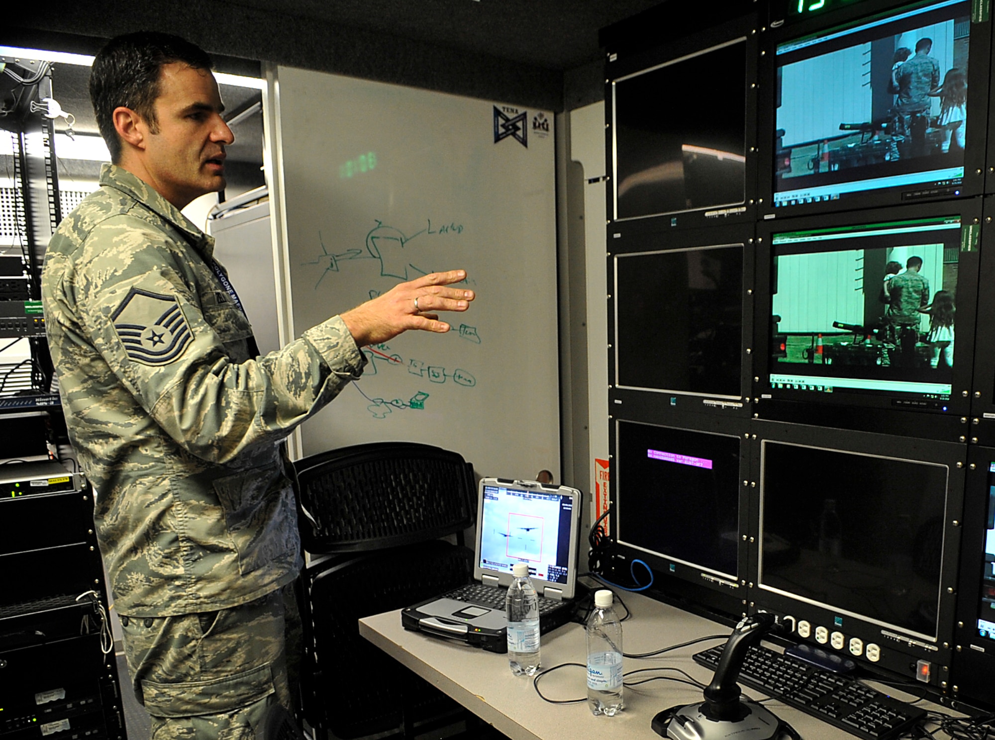 Master Sgt. John Zelinski, Polygone Electronic Warfare Training Range Live, Virtual, Constructive program manager, explains the capabilities of the Multinational Aircrew Electronic Warfare Training Facility Live Virtual Constructive Training System (MALTS) during an open house Aug. 25, 2016, at Einsiedlerhof Air Station, Germany. As a detachment of the Warrior Preparation Center, Polygone uses MALTS to deliver world-class Integrated Air Defense System simulation anywhere in the world. (U.S. Air Force photo/Senior Airman Larissa Greatwood)