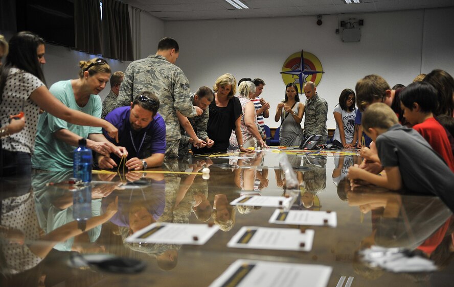 Warrior Preparation Center Airmen and their families participate in a game to see who can build the tallest free-standing structure out of spaghetti noodles and marshmallows during an open house Aug. 25, 2016, at Einsiedlerhof Air Station, Germany. The activity demonstrated the importance of pre-planning, which is applied in the WPC mission. (U.S Air Force photo/Senior Airman Larissa Greatwood)