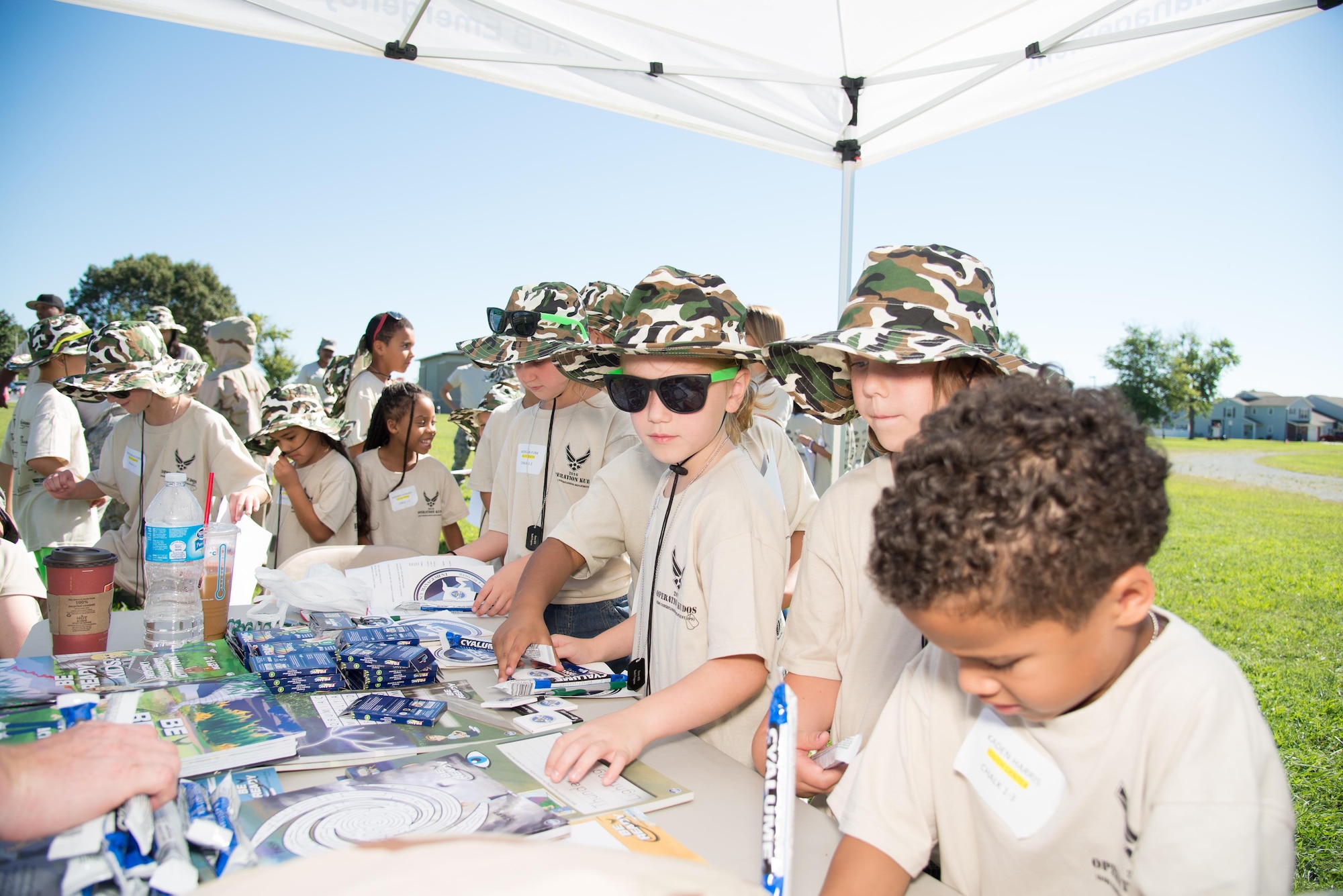 Participants of the Kids/Teachers Understanding Deployment Operations event receive coloring books and crayons Aug. 23, 2016, at Dover Air Force Base, Del. The annual event helps school age children of active duty service members and their teachers understand what it's like to deploy overseas. (U.S. Air Force photo / Mauricio Campino)