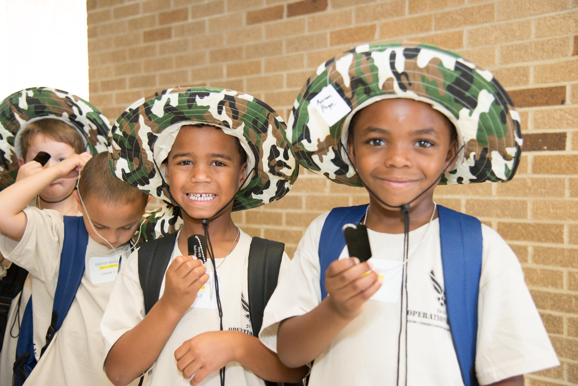 Participants receive their "dogtags" during the Kids/Teachers Understanding Deployment Operations event Aug. 23, 2016, at Dover Air Force Base, Del. The annual event helps school age children of active duty service members and their teachers understand what it's like to deploy overseas. (U.S. Air Force photo by Mauricio Campino)